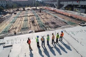 construction site with 7 people stood watching